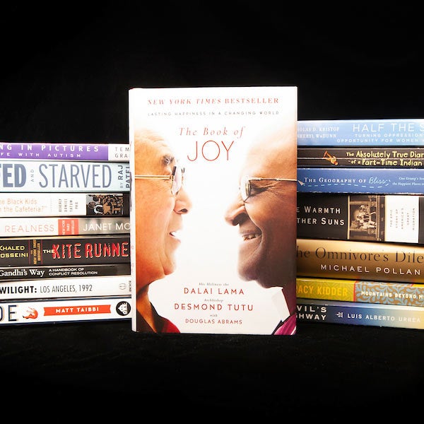 A stack of books featuring a book about Joy