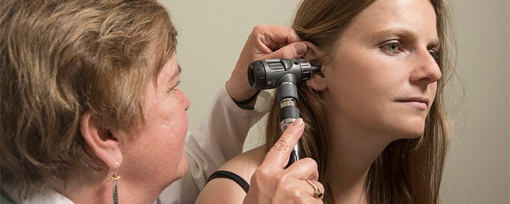 Student gets ear inspected.