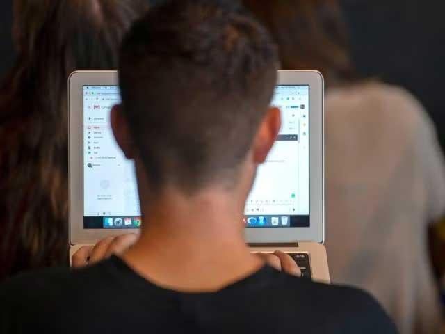 Man facing laptop